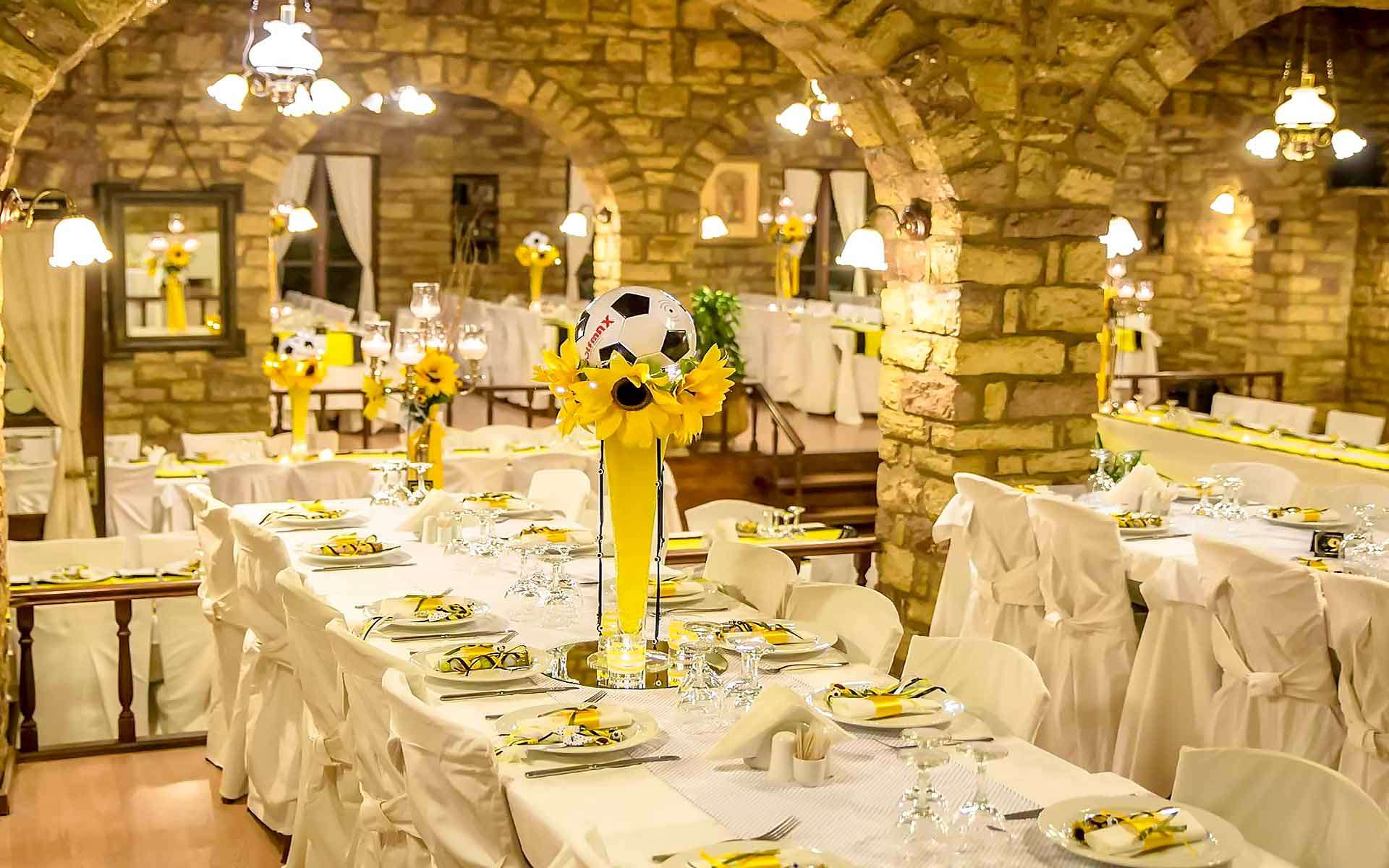 Unique-Baptism-Party-Idea-With-Yellow-And-Black-Colors-And-A-Ball-As-A-Centerpiece-In-A-Tall-Vase