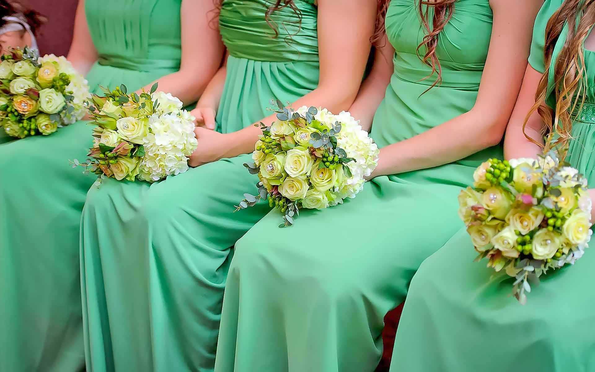 Ladies-In-Emerald-Each-Dressed-Up-Holding-Their-Wedding-Bouquets