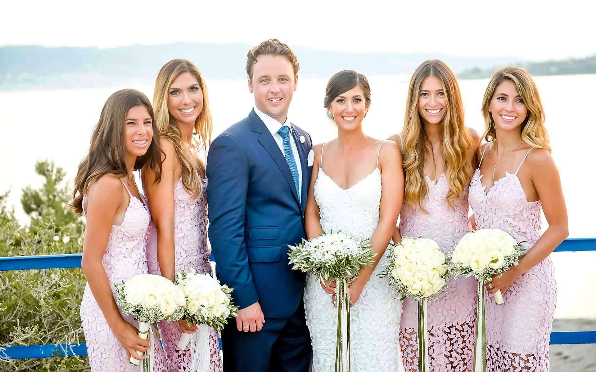 The-Couple-With-Their-Bridesmaid-Holding-Their-Wedding-Bouquets-With-White-Roses-With-Olive-Leaves-With-Olive-Leaves