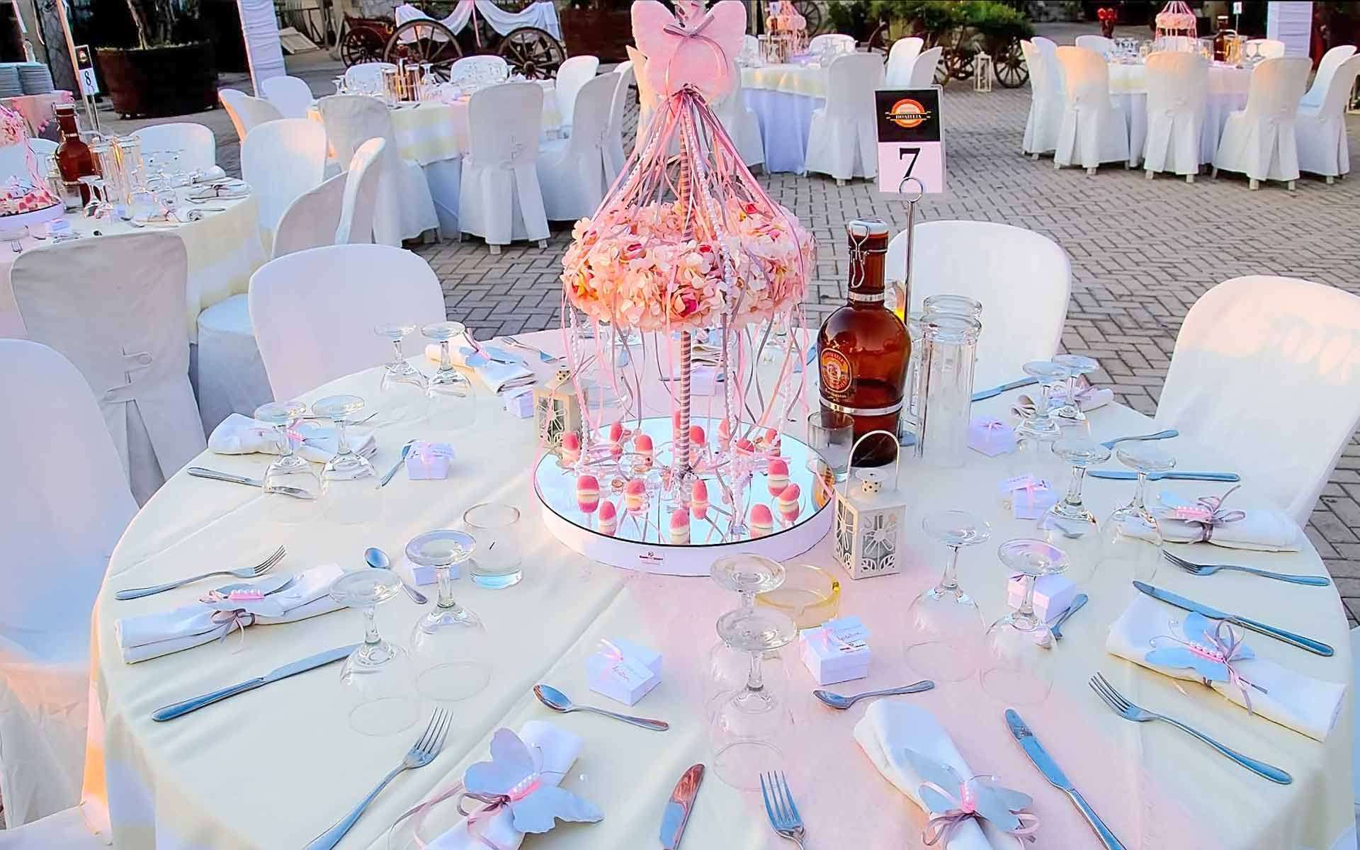 Table-Decoration-With-Pink-Carousel-In-Shades-Of-Pink-With-Floral-Wreath-And-Pink-Ribbons