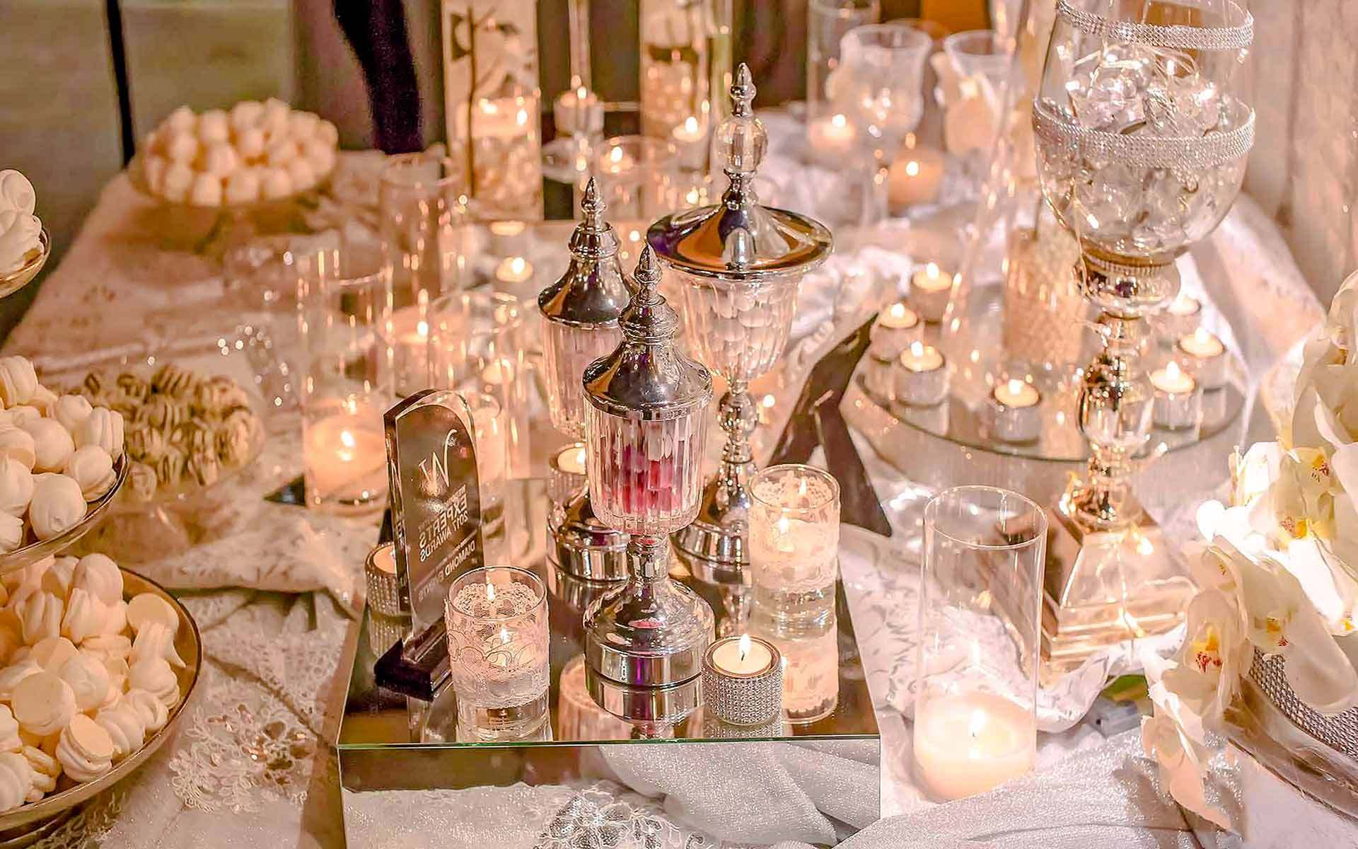 Glamorous-wedding-Guestbook-table-with-white-orchids-crystals-vases-mirrors-and-desserts