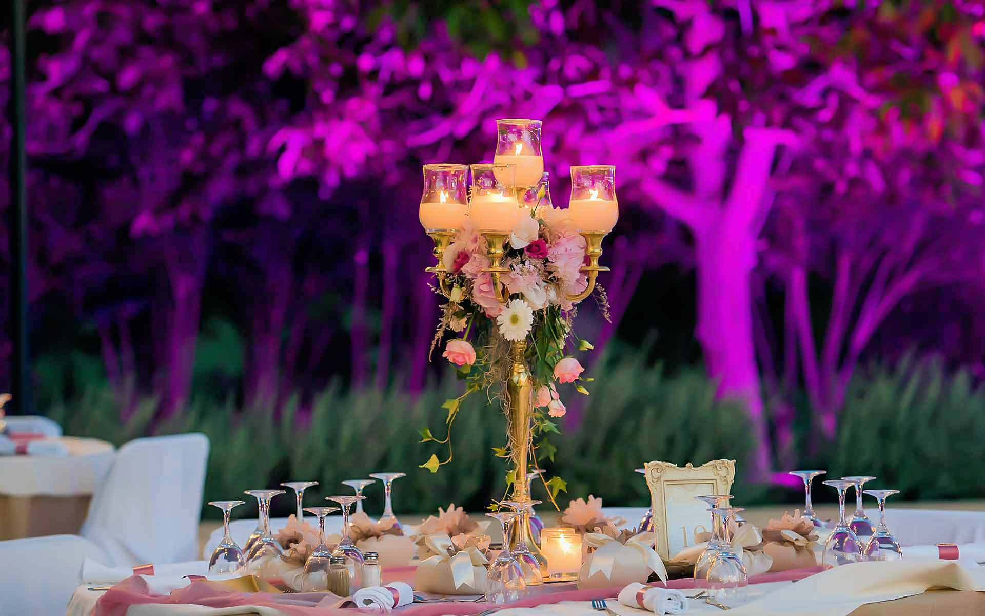 A tall gold candelabra & a stunning floral bouquet provides an elegant wedding centerpiece