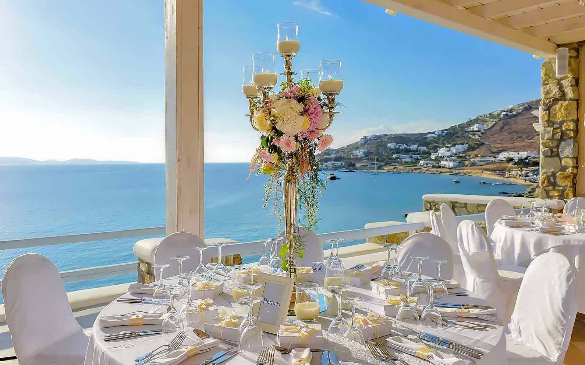Candelabra As A Centerpiece With The Sea Of Mykonos As A Background by Rogdaki Events Trademark wedding & Events