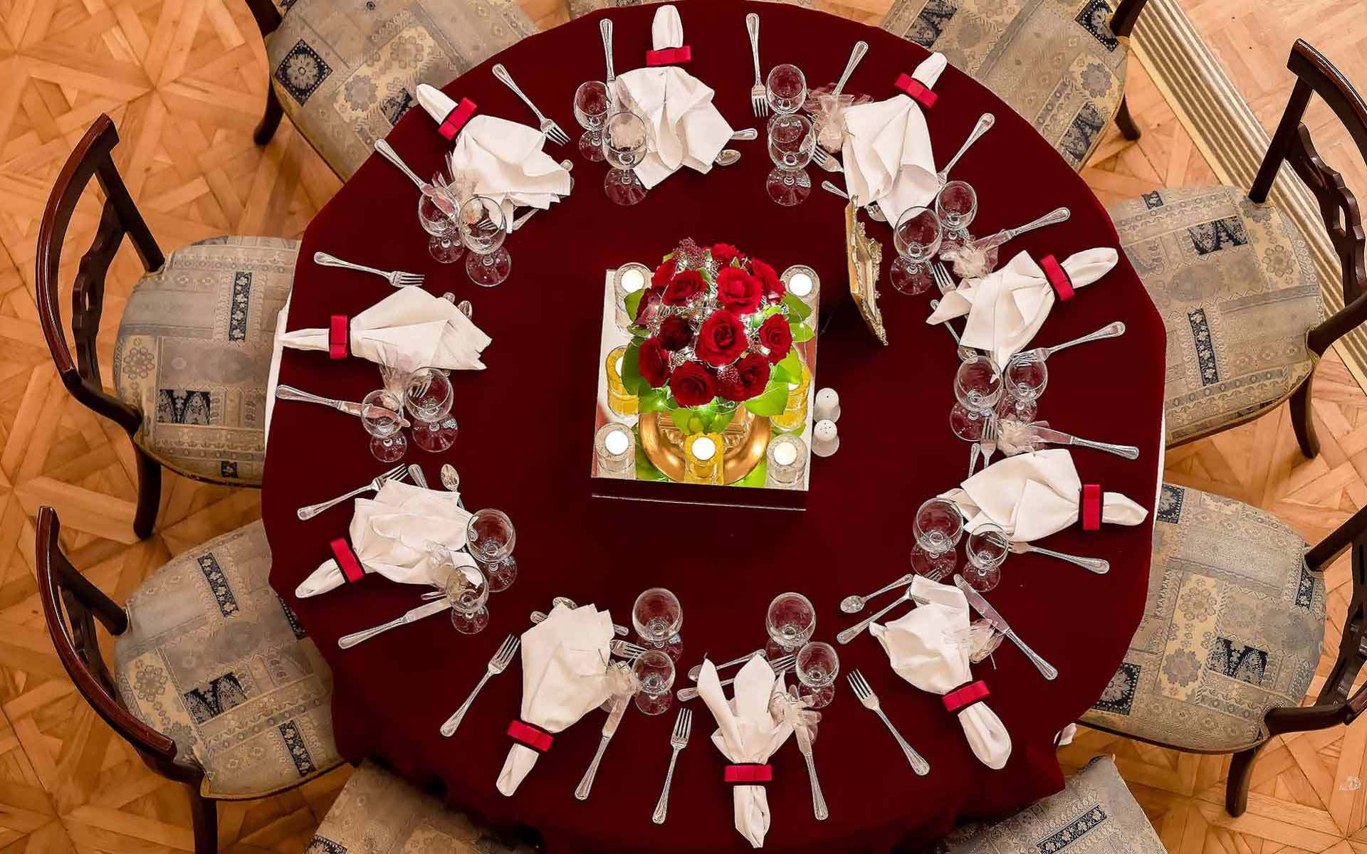 Christmas wedding table set up in Bordeaux tablecloth and red roses