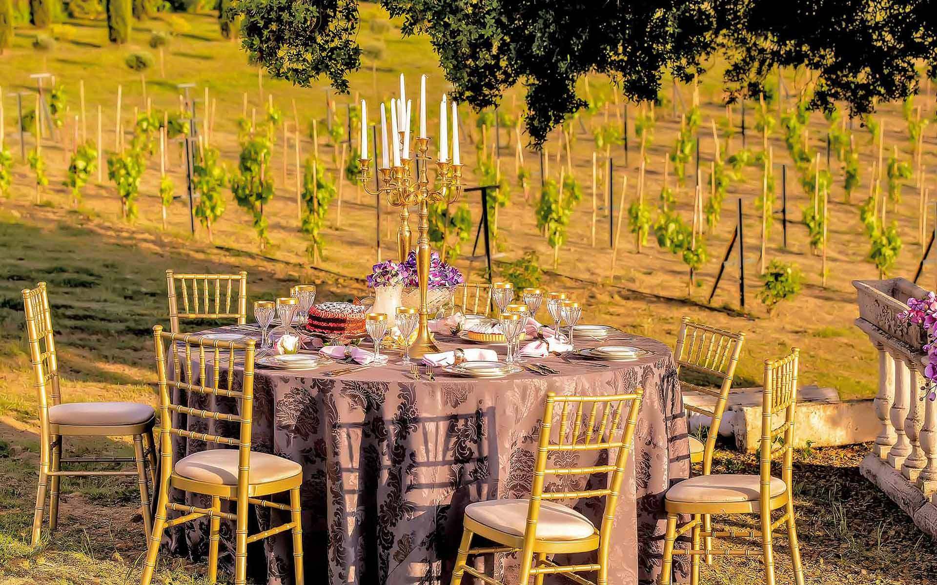 Gold Candelabra Centerpieces with Hydrangea in a field by Rogdaki Events Trademark