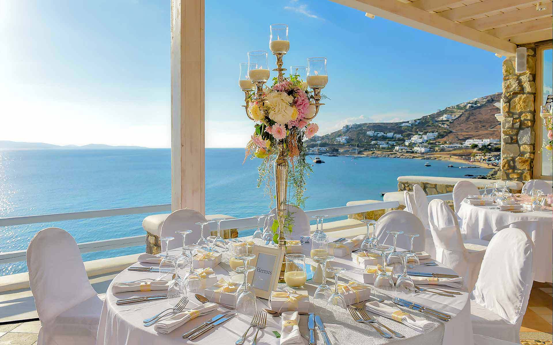 Candelabra-As-A-Centerpiece-With-The-Sea-Of-Mykonos-As-A-Background