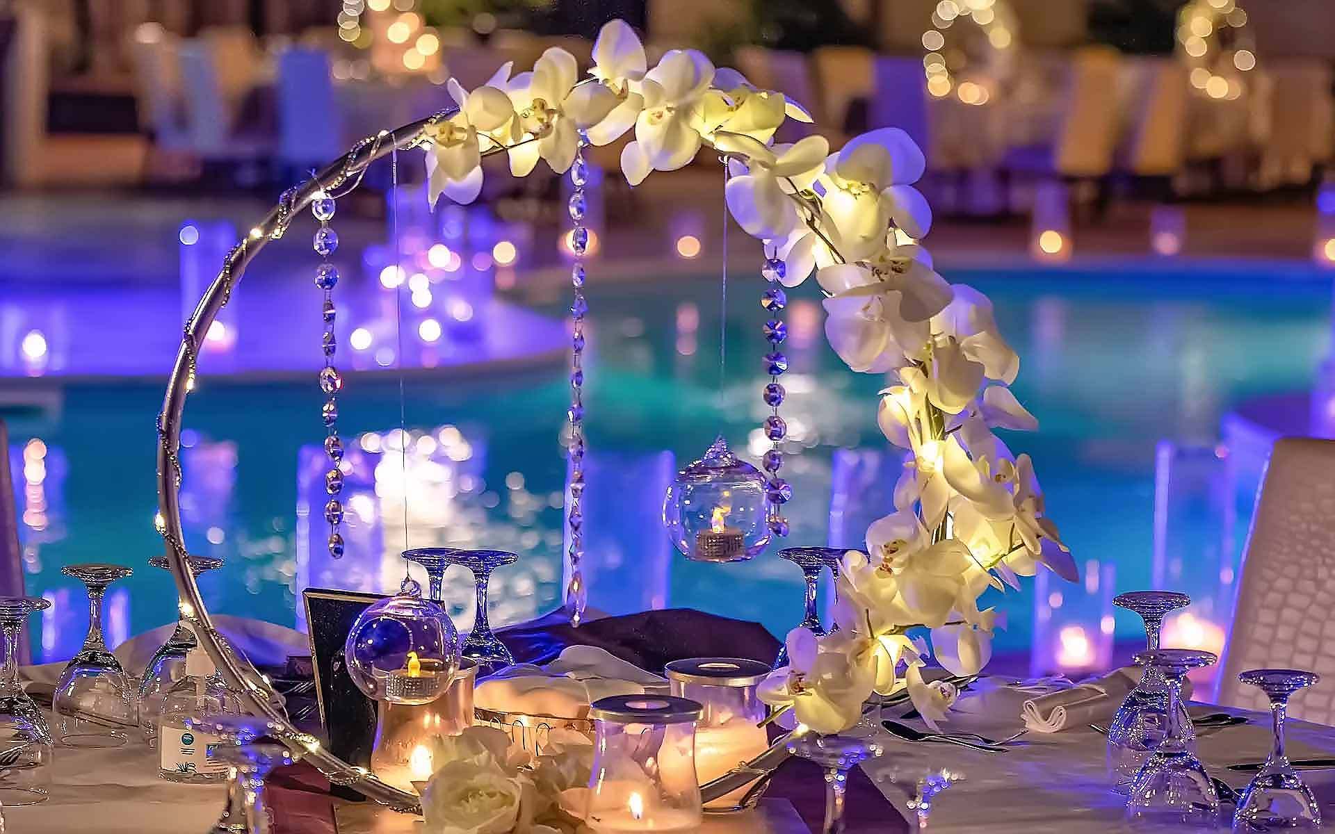 Wedding arch - metal round backdrop for wedding decor with hanging crystals & white Phaelaenopsis Orchids by Rogdaki Events Trademark