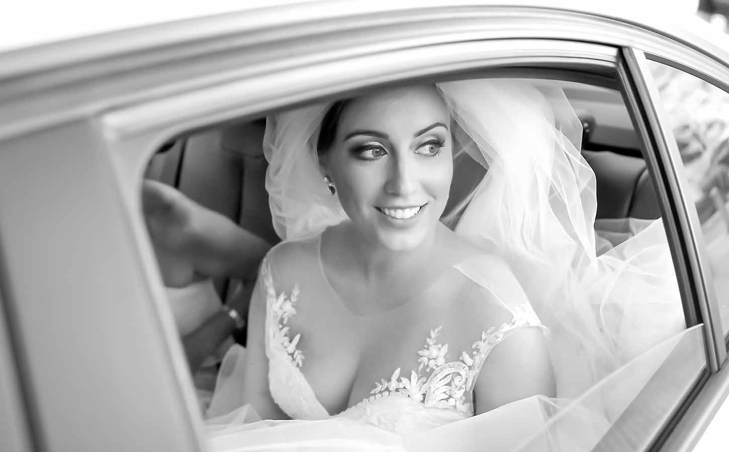 A beatiful bride inside the wedding car