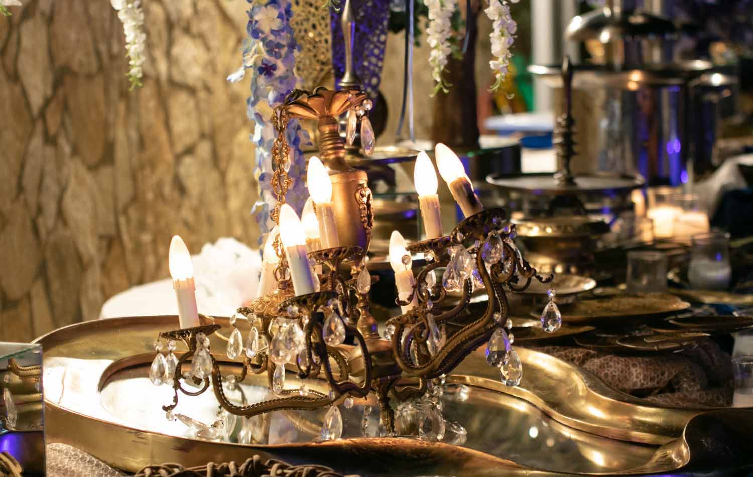 A rustic golden candelier alternatively added as a decorative element on the buffet by Diamond Events
