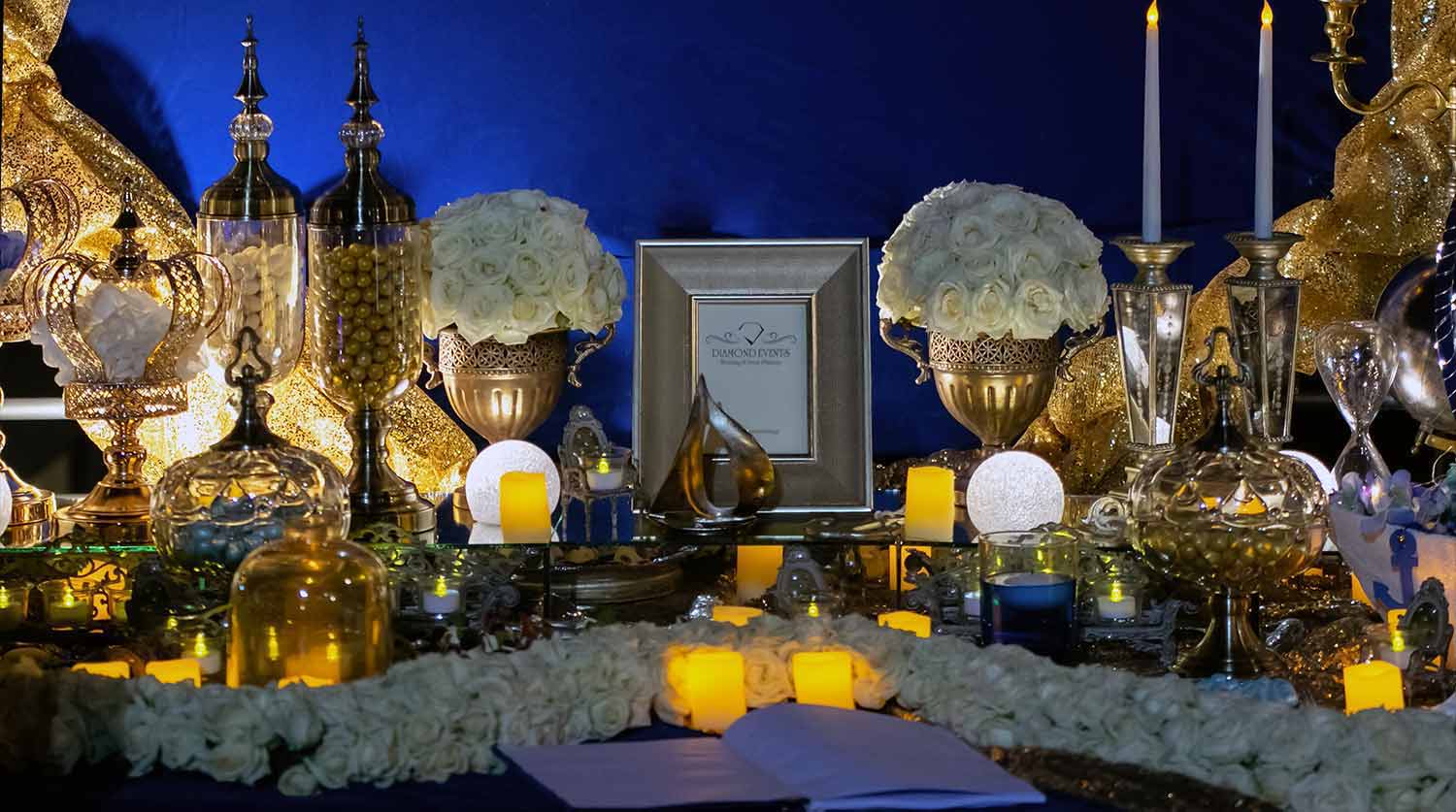 Minimalistic flower compositions with white roses offer a brighter tone at a velvet navy blue backgroundby Diamond Events