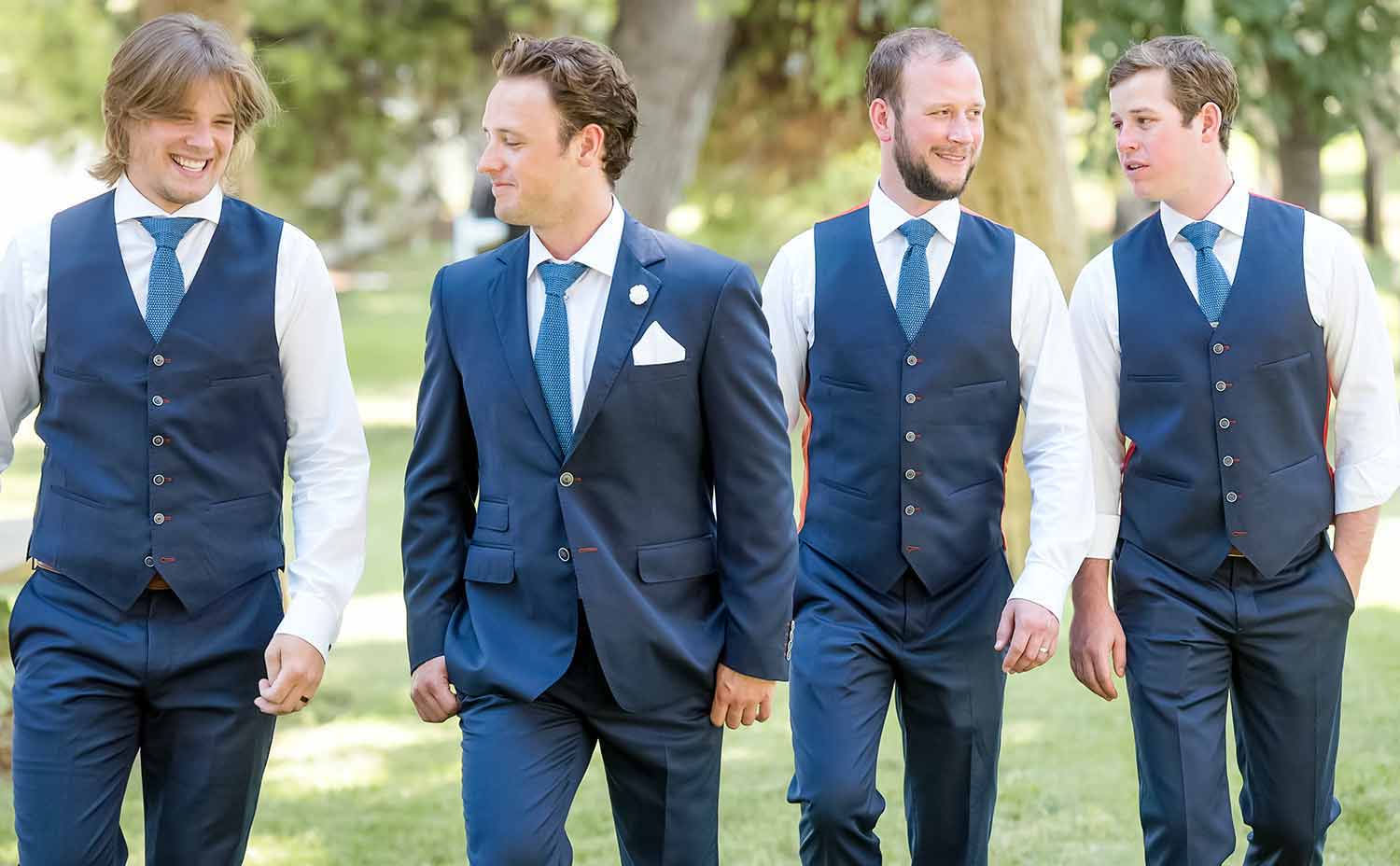 A groom with his groomsmen walking together