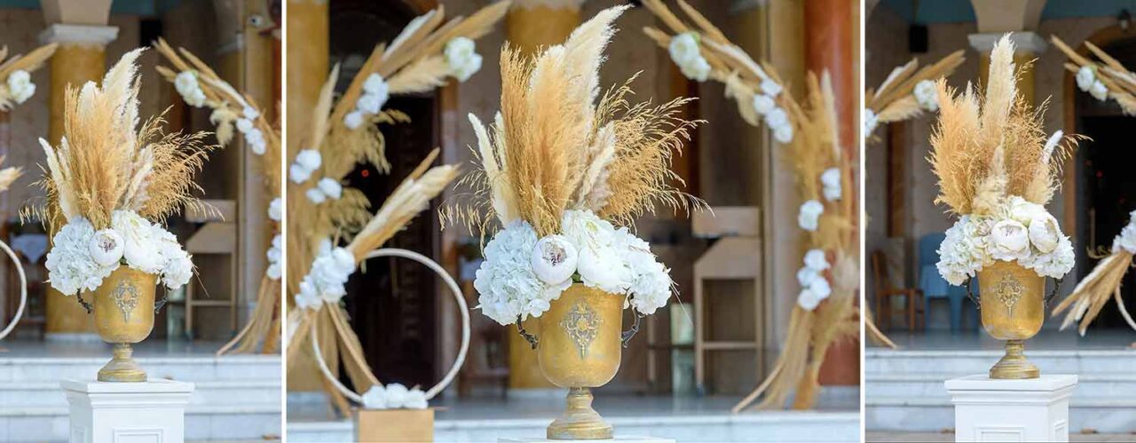 A two piece arch gold urns and two gold circles of life decorated with pampas grasses and white roses form an imressive entrance 4