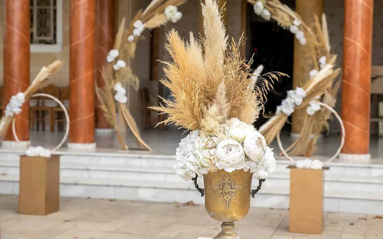 Metallic gold urn decorated with pampas grasses white roses and white peonies by Diamond Events 2
