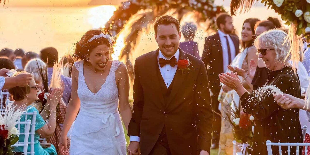 The happily couple walking down the aisle at their Great Gatsby Wedding by Rogdaki Events trademark