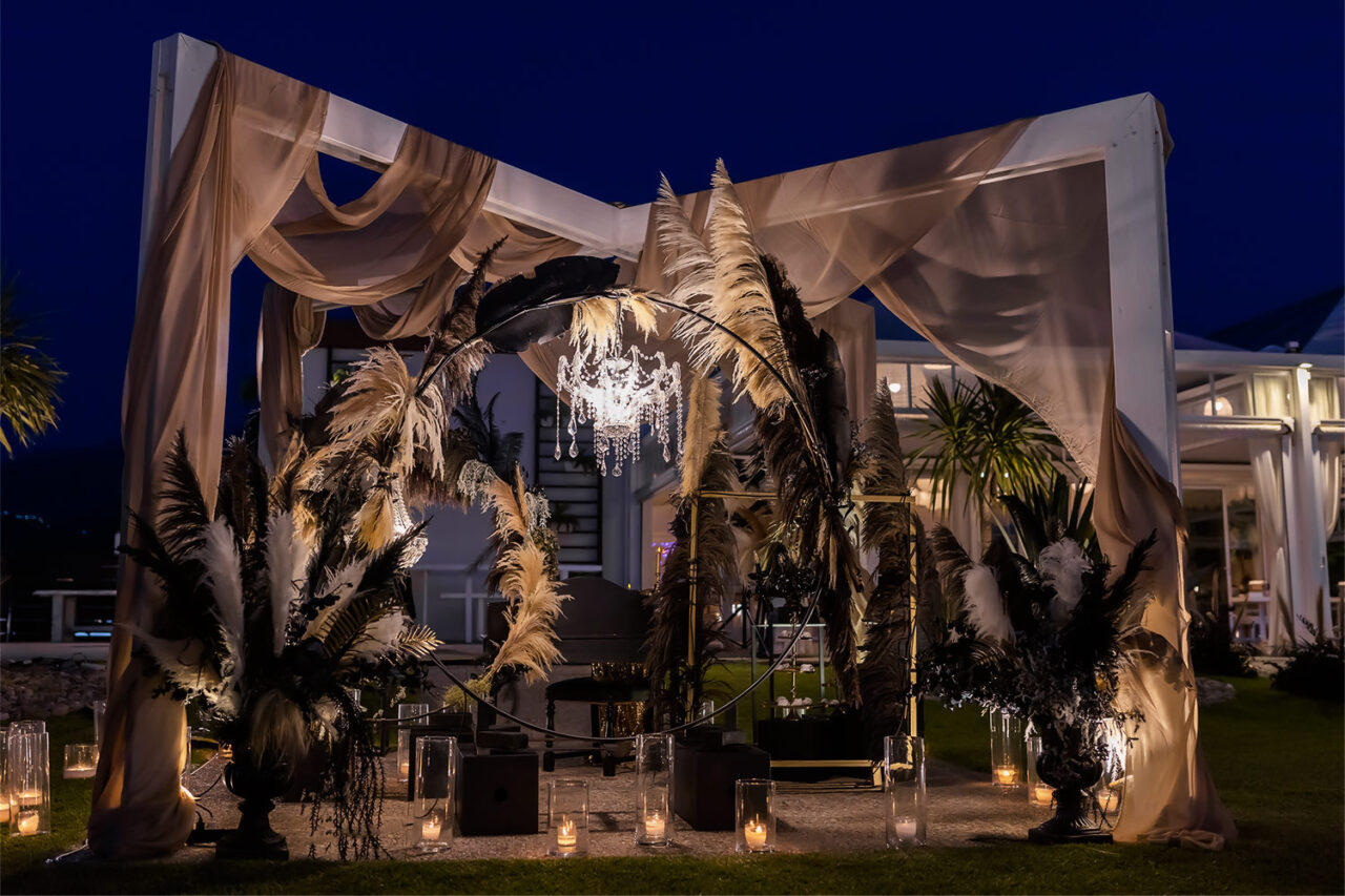 A magical schenery as a wedding guest book table in black and gold setting the scene for rogdaki events at the exclusive Omega Yacht Club where timeless elegance meets celebration