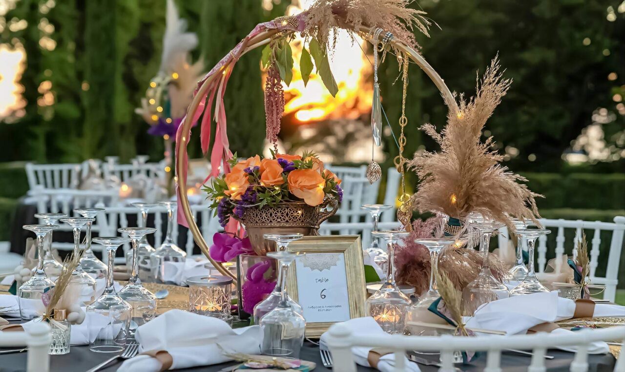 The circle of life decorated with pampas grass and natural roses used as a centerpiece alongside a gold urn inspired by the East culture by Rogdaki Events