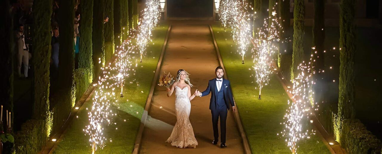 Welcoming the happy couple in a corridor of fireworks at the private villa by Rogdaki Events