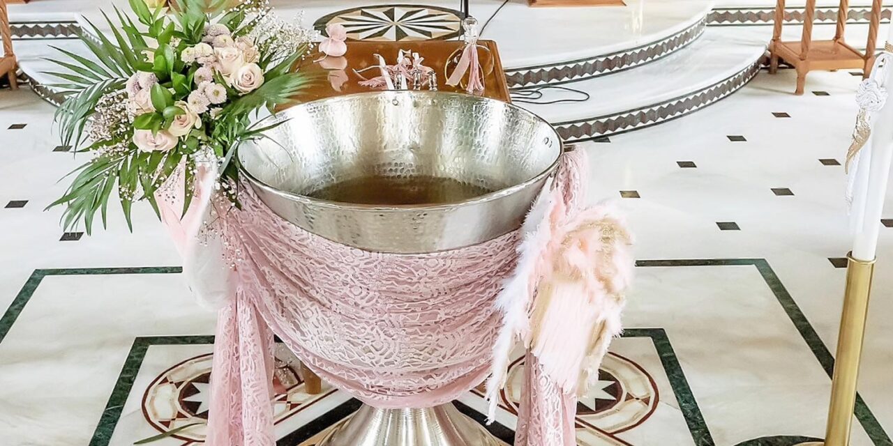 A Miracle Girl Baptism at Royal Theater — sacred water, pink lace, and angel wings bless the beginning of her path