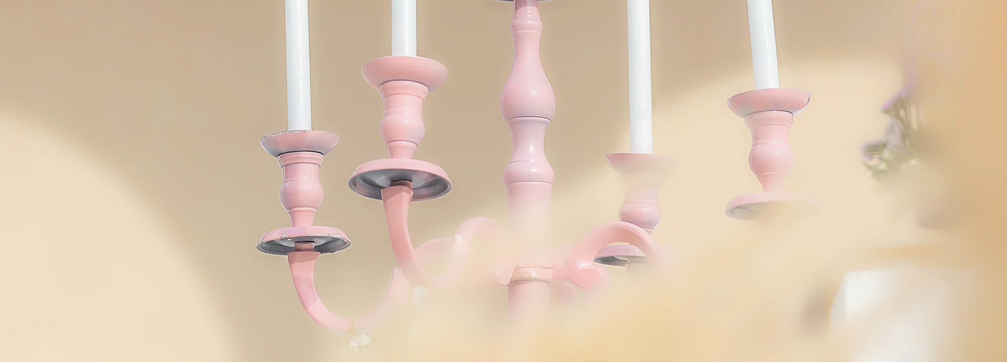 Soft pink candelabra with white candles — elegance, purity, and the glow of a miracle day.