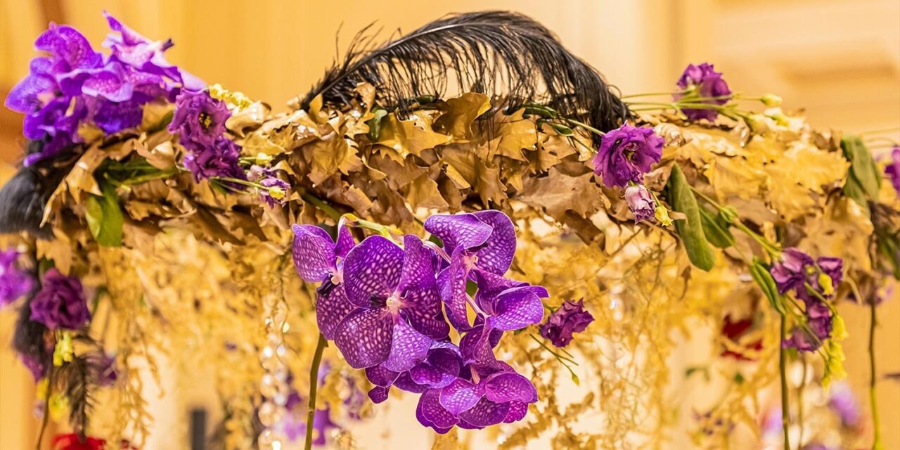 Lavish gold, red, and purple floral arrangements by Rogdaki Events for Grande Bretagne ballroom luxurious gala dinner scene