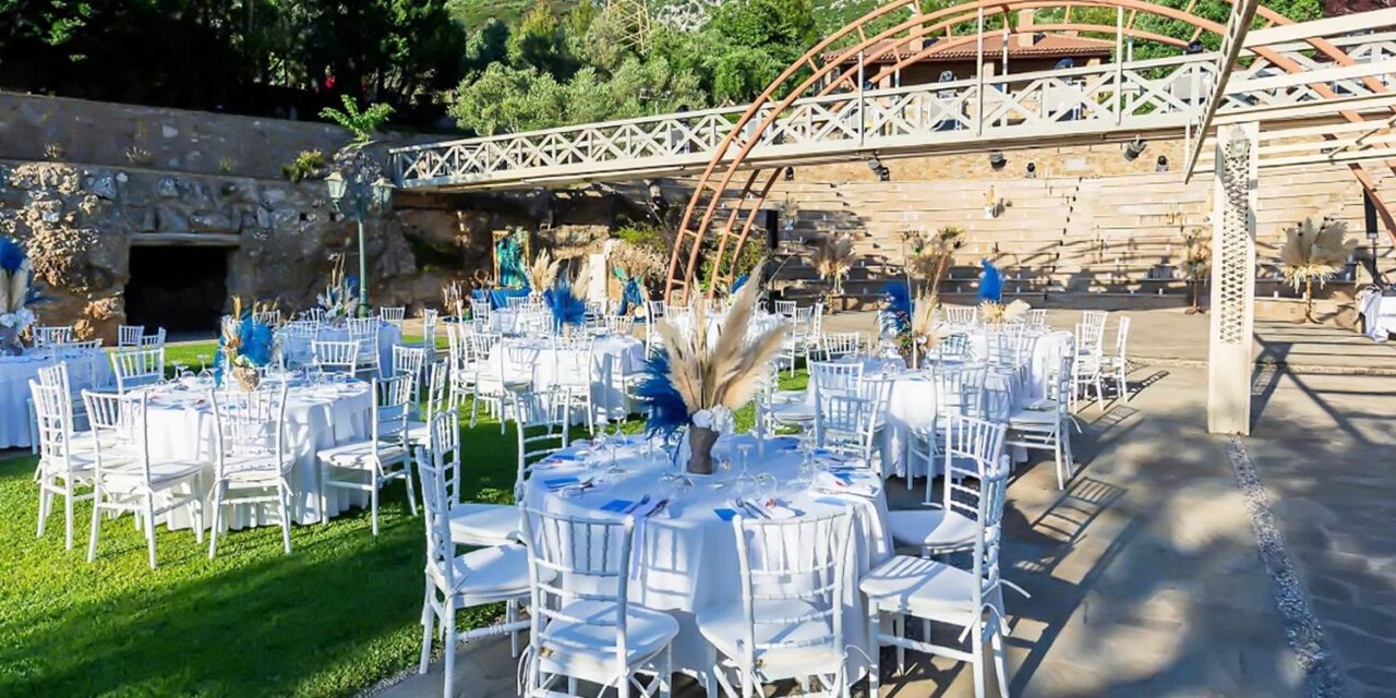 Ancient Greek Decor in an Amphitheater, by Rogdaki Events — The couple crowned with laurel wreaths in a symbolic ritual echoing timeless Hellenic traditions