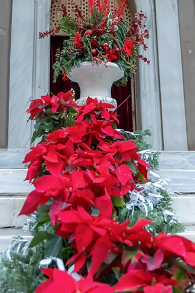 Rogdaki Events creates a festive canopy with greenery, ornaments, and fairy lights for an elegant Christmas baptism
