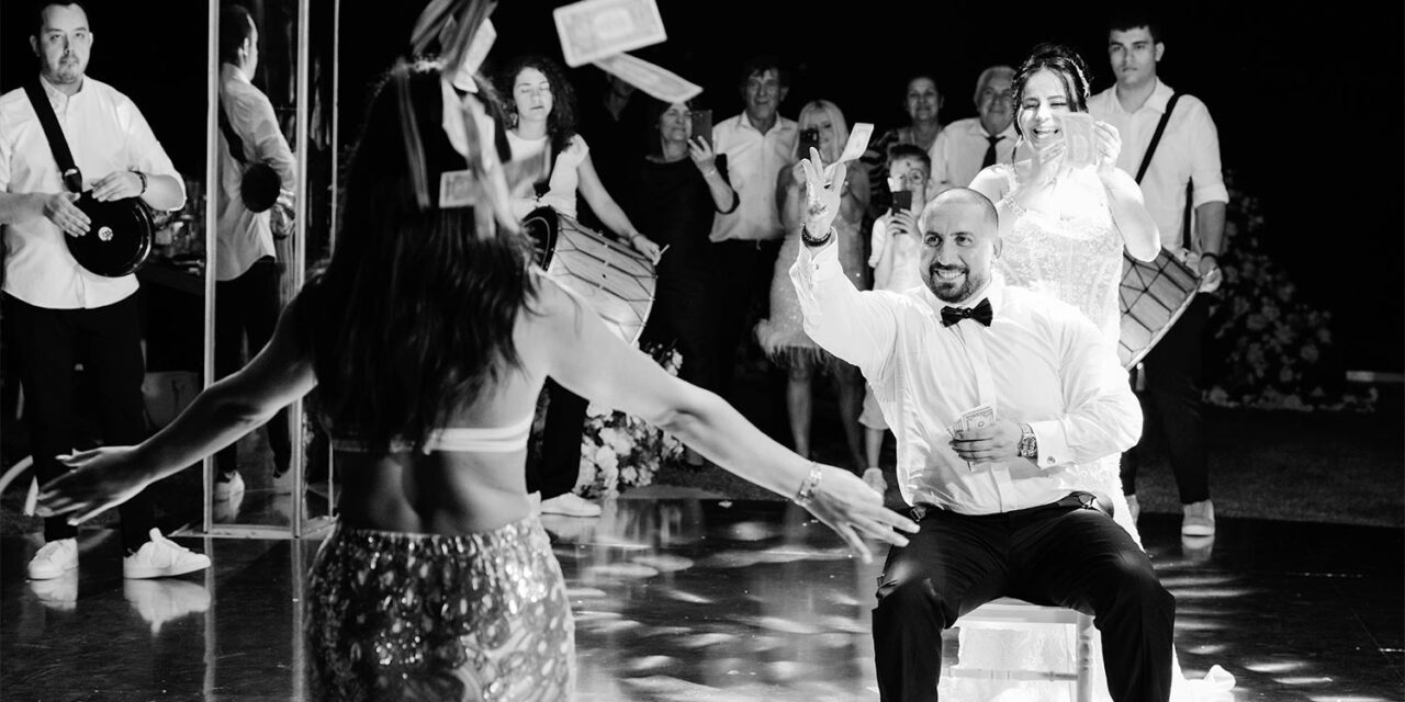 Joyful groom celebrates entertainment at a Luxury Seaside Wedding in Greece by Rogdaki Events