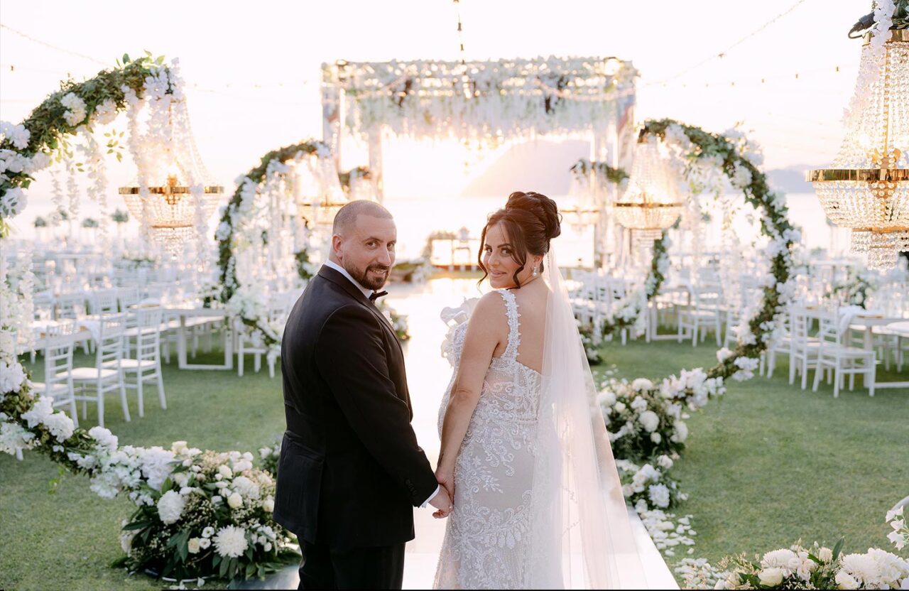 Luxury Seaside Wedding in Greece by Rogdaki Events, couple glowing under golden sunset aisle