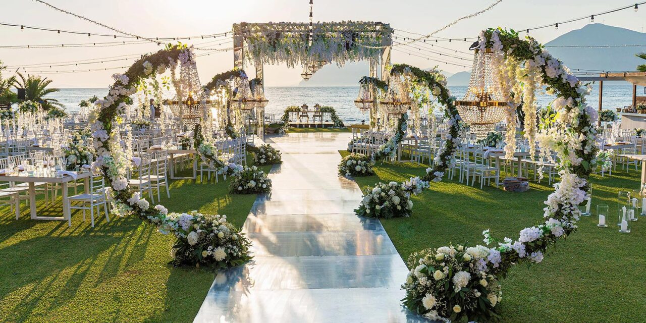 Rogdaki Events created a breathtaking aisle for this Luxury Seaside Wedding in Greece, adorned with arches and crystal chandeliers