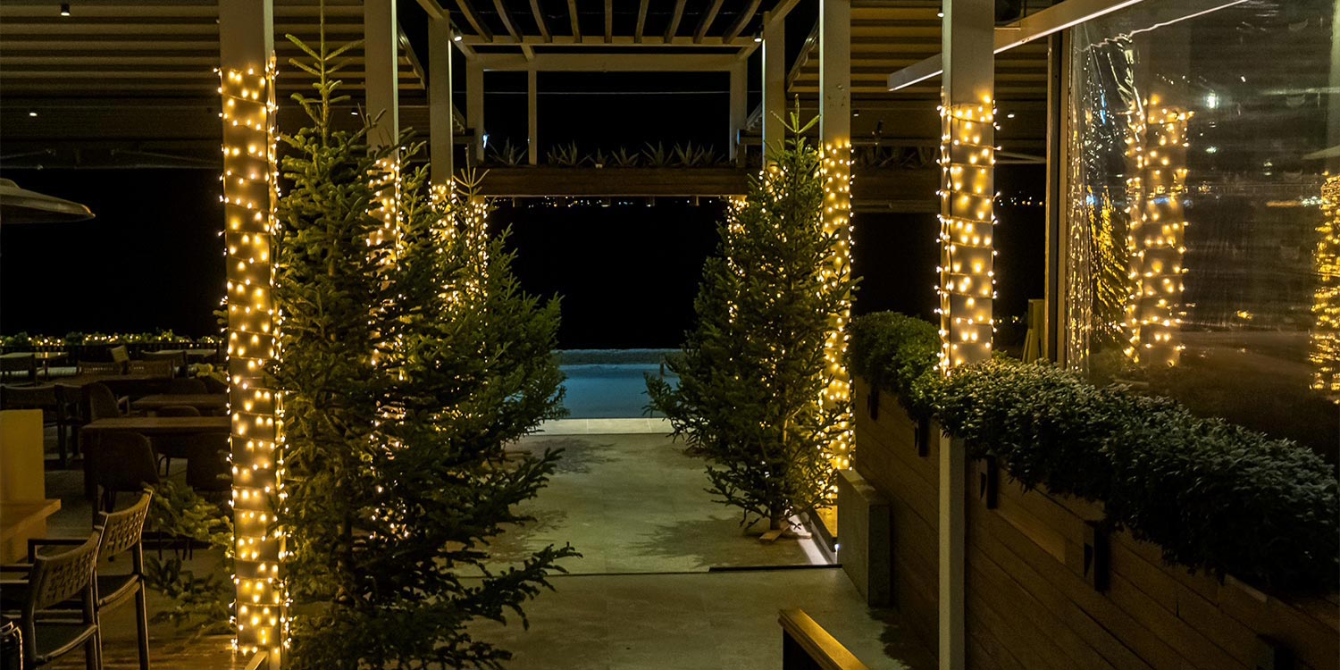 Mesmerizing Christmas Baptism Decoration 22 Christmas baptism patio by Rogdaki Events at Distinto—twinkling trees, glowing columns, and serene poolside charm