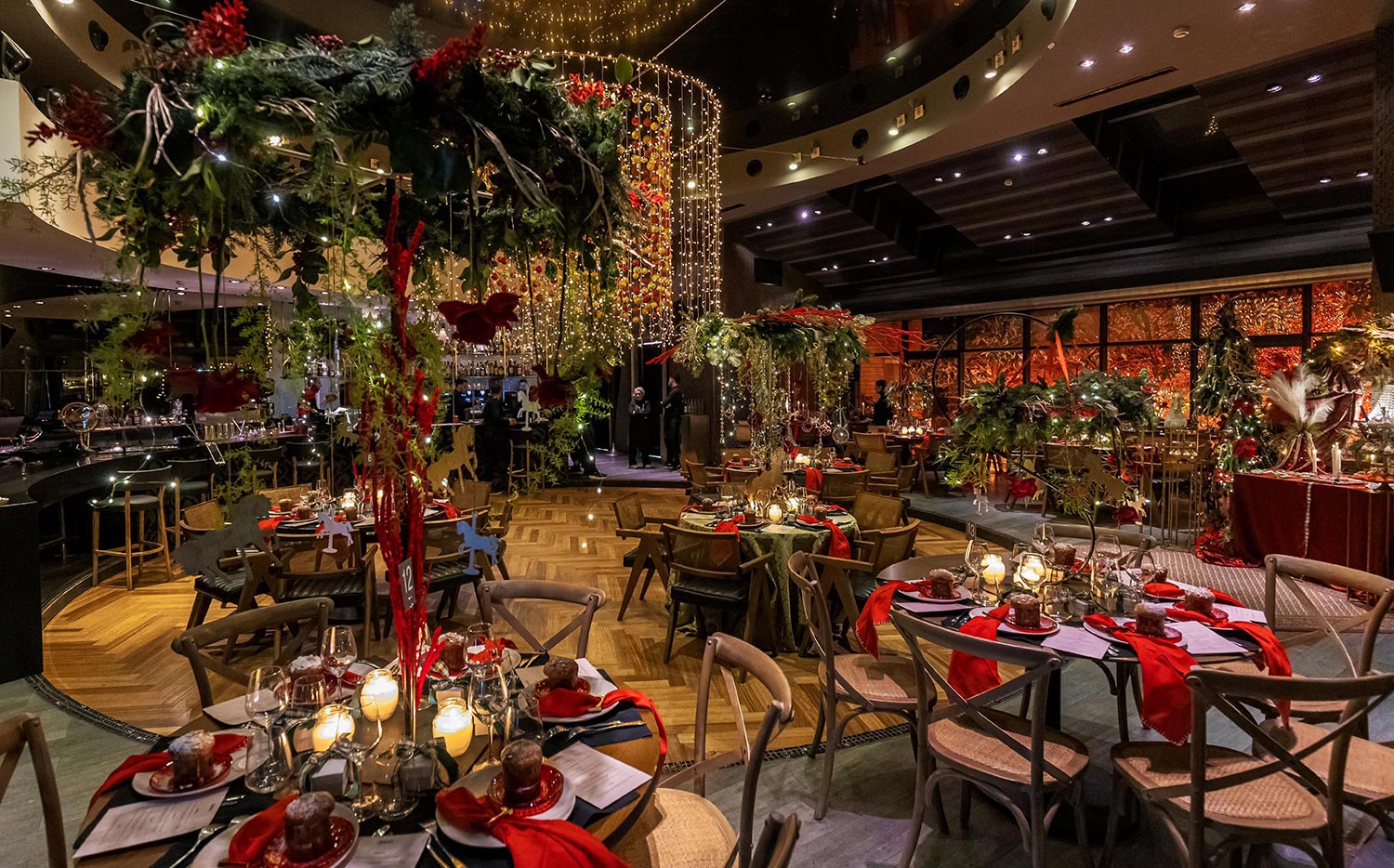 Mesmerizing Christmas Baptism Decoration 20 Rogdaki Events created a festive Christmas baptism at Distinto, featuring lush greenery, red accents, and hanging golden fairy lights