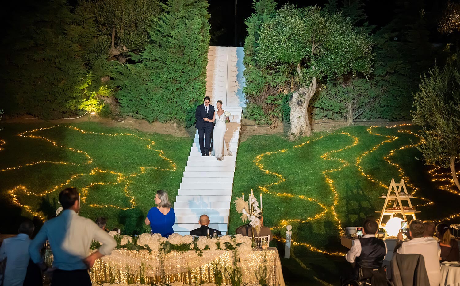 Greek‑French Chic Wedding 28 A couple descends stairs at an Idilofon wedding planned by Rogdaki Events.