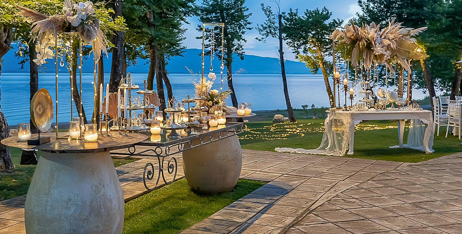 Trichonida Lake Wedding 30 A dreamy lake wedding by Rogdaki Events at Pithari, featuring elegant dessert tables set against a scenic twilight backdrop