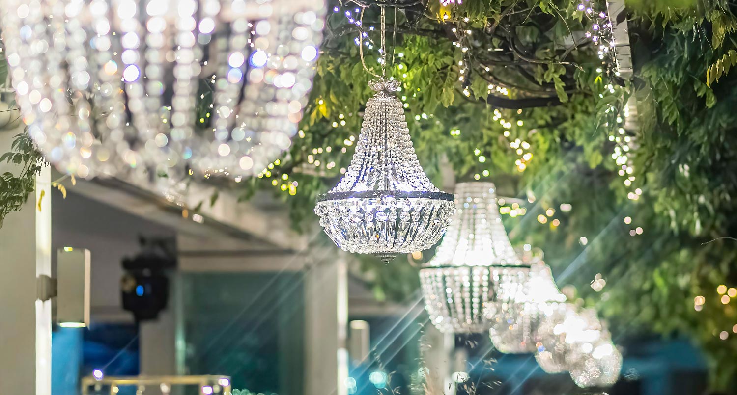 Trichonida Lake Wedding 36 Crystal chandeliers sparkle under foliage—Rogdaki Events transforms Pythari into a magical lake wedding venue under the stars