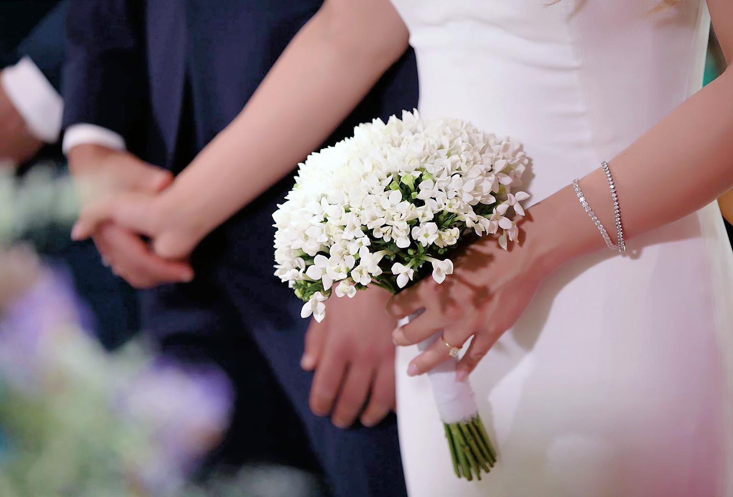 A Signature Wedding & Baptism Production in Blue 12 Elena holds a bouquet of Lily of the Valley, the ultimate choice for timeless aesthetics.