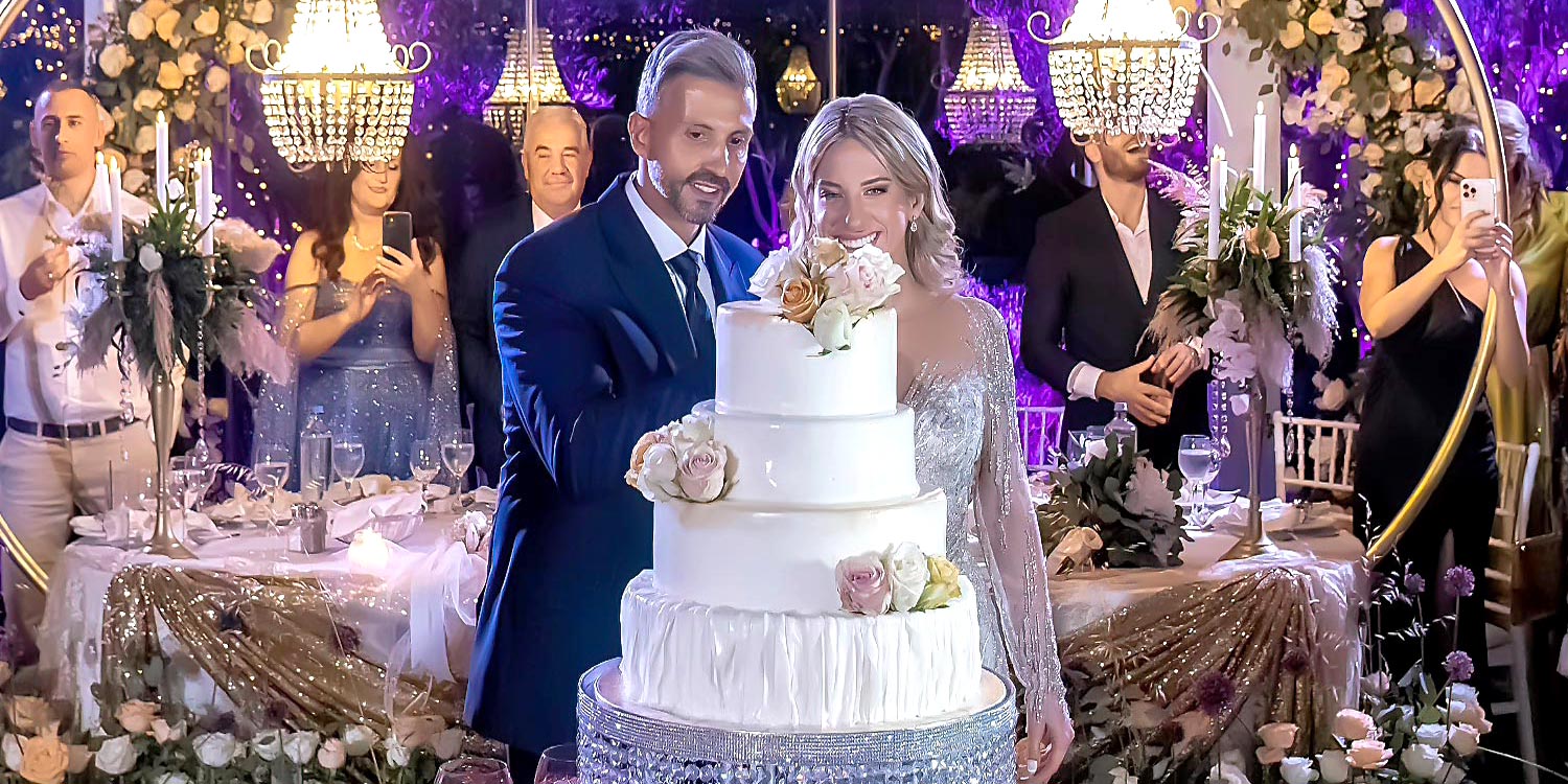 Trichonida Lake Wedding 39 Lake wedding at Pythari by Rogdaki Events—crystal chandeliers, pastel florals, and a joyful cake cutting moment in elegance.