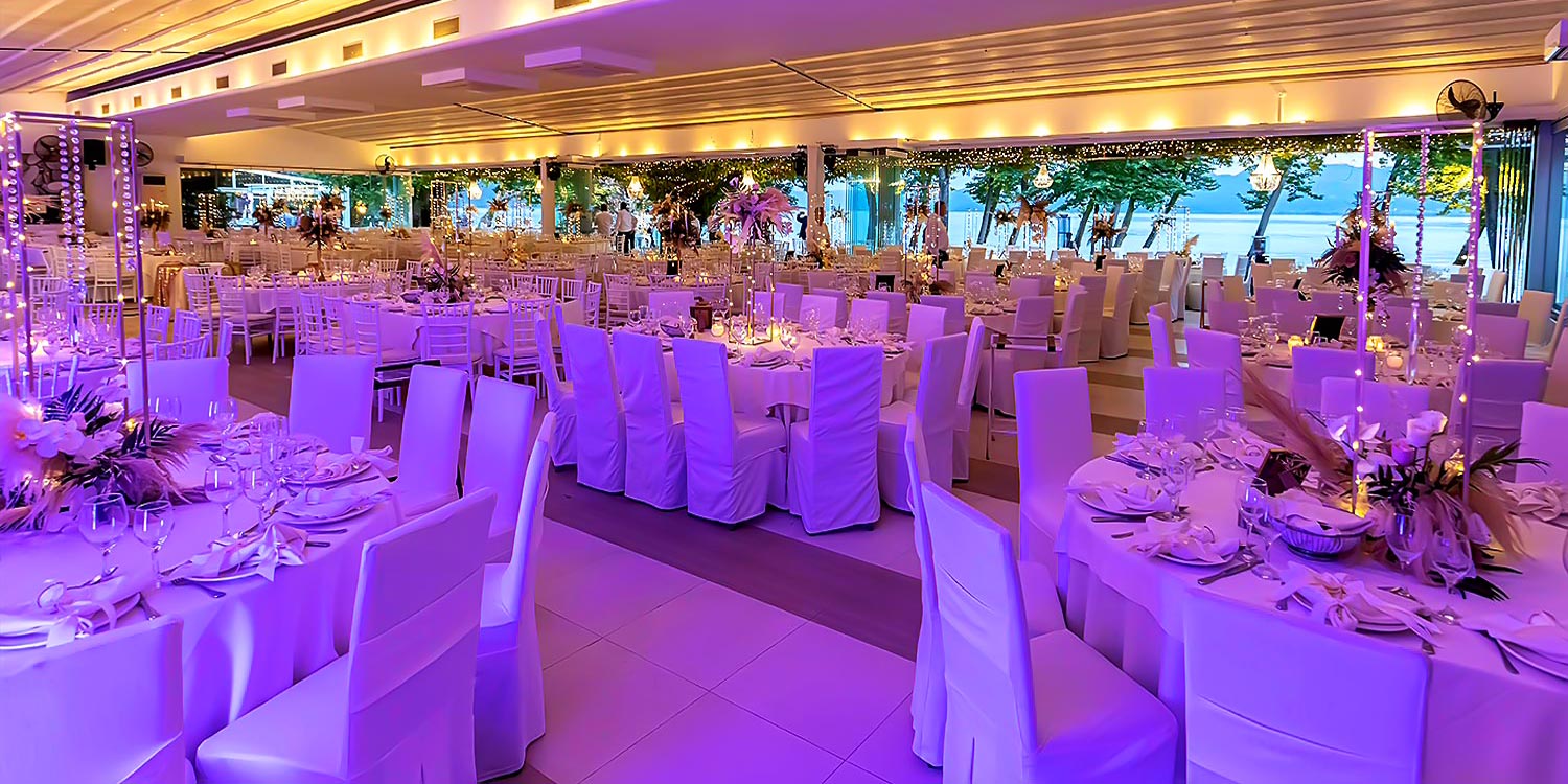 Trichonida Lake Wedding 24 Lake wedding at Pythari by Rogdaki Events—purple glow, feather florals, and candlelit tables with serene water views