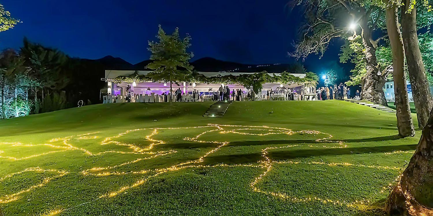 Trichonida Lake Wedding 40 Lake wedding at Pythari by Rogdaki Events—string lit lawn, glowing pavilion, and magical ambiance under the night sky