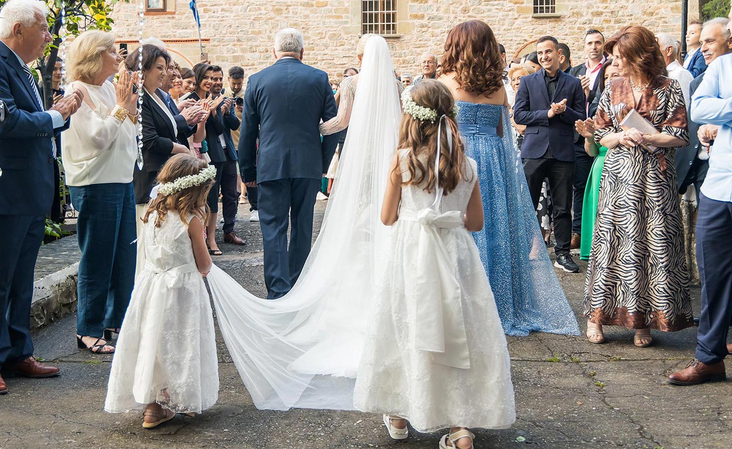 Trichonida Lake Wedding 14 Rogdaki Events celebrated this joyful ceremony in agrinio with veil bearing flower girls and heartfelt applause