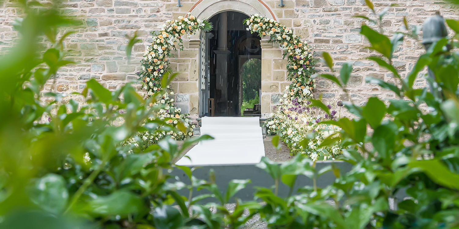 Trichonida Lake Wedding 1 Rogdaki Events designed this romantic ceremony in agrinio with soft florals and a graceful stone backdrop.
