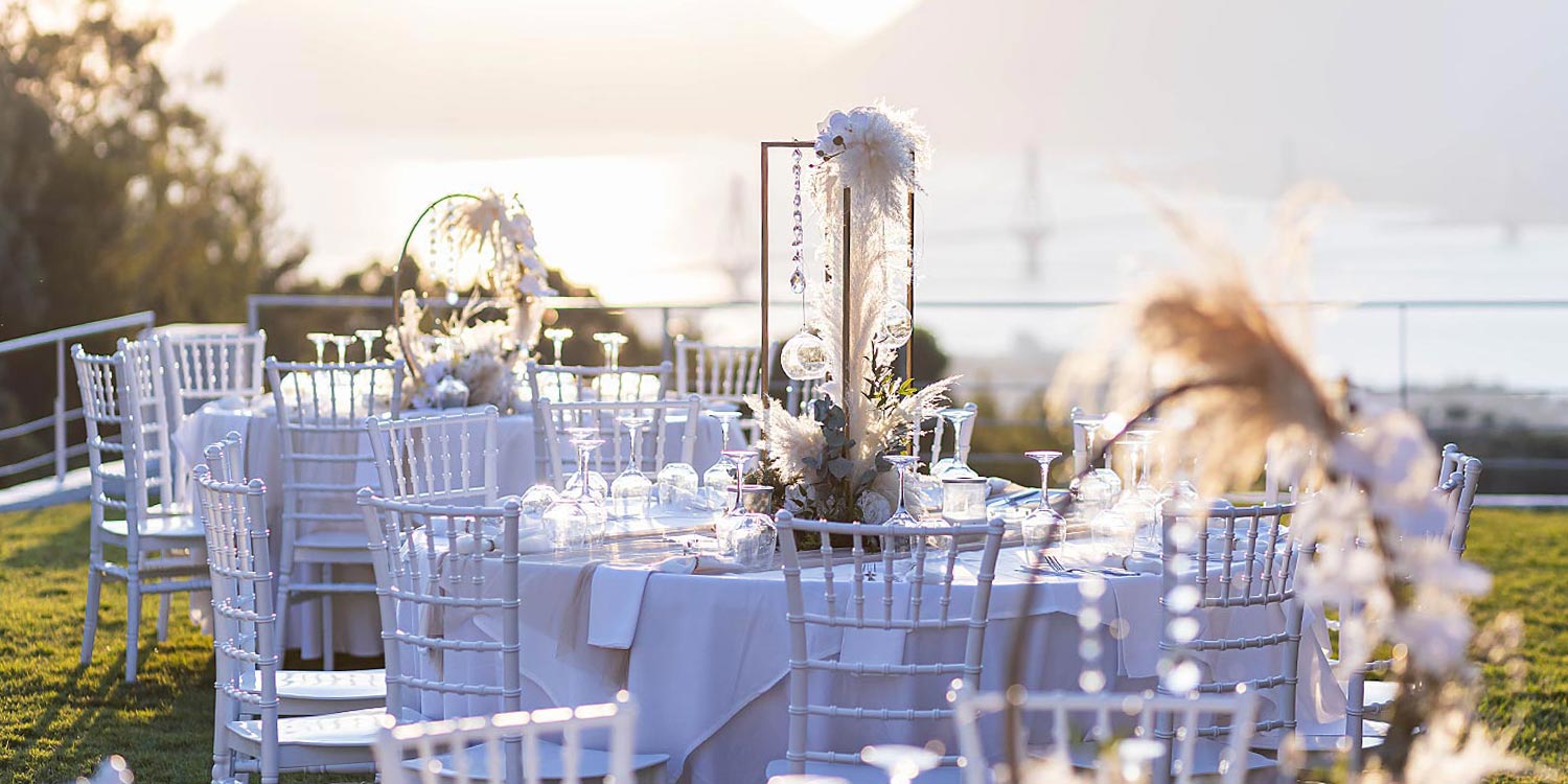 Greek‑French Chic Wedding 20 Sunset view of table settings planned by Rogdaki Events at the Idilofon venue.