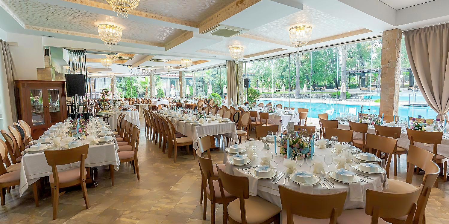 A Signature Wedding & Baptism Production in Blue 13 Wedding reception in Agrinio by Rogdaki Events, featuring set tables at Korali with a poolside view.