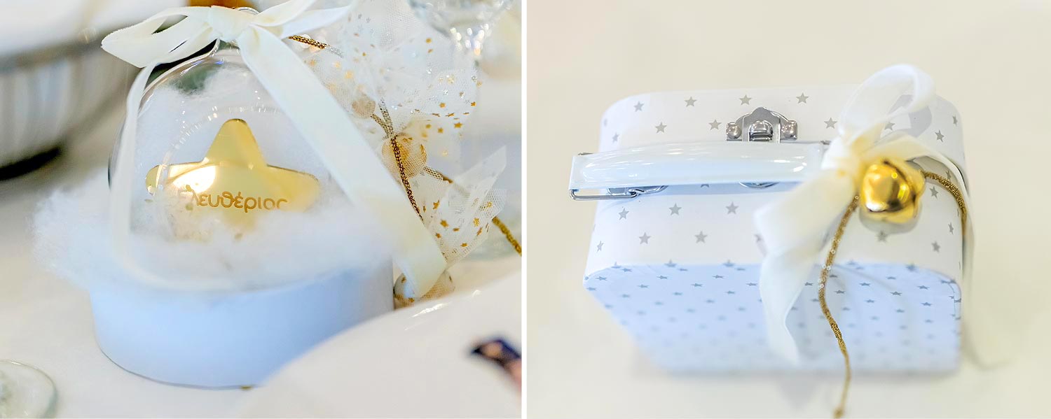 Dome‑style favor with a gold star and suitcase favor with tiny stars and gold details by Rogdaki Events.