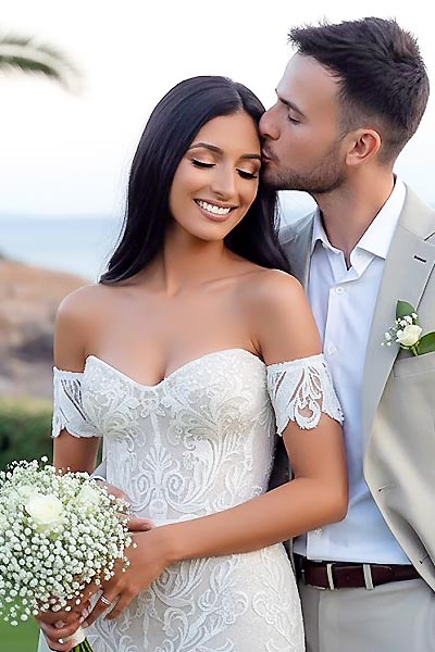 James is kissing Daniela, after their wedding featuring minimal decoration by Rogdaki Events at Ktima 48.