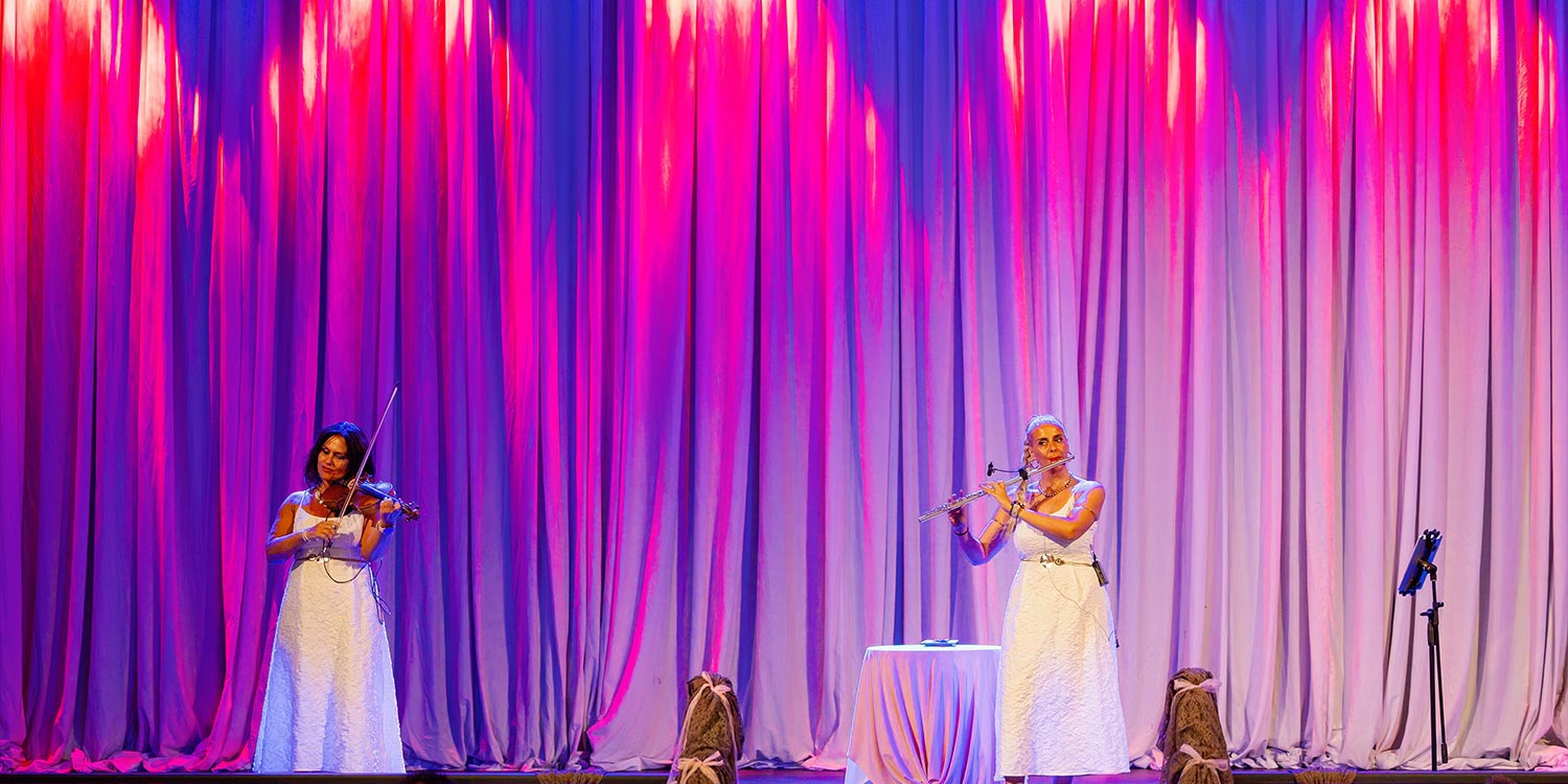 A Bridgerton Wedding in Greece 43 Musicians with violin and flute performing at the Royal venue reception, for an event by Rogdaki Events.