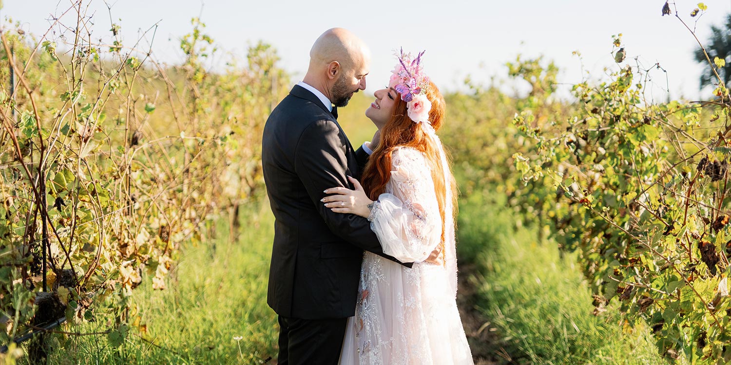 A Bridgerton Wedding in Greece 53 The couple in a romantic moment in the vineyard, with the bride wearing a stunning flower crown, in a post wedding photoshoot