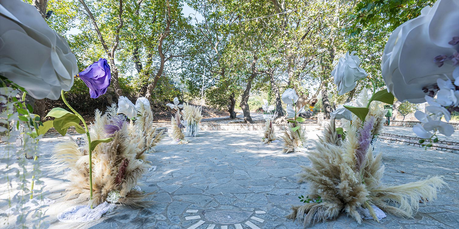 Whimsical Forest Christening with Oversized Floral Decor 5 Boho chic forest christening path with giant white and purple flowers by Rogdaki Events