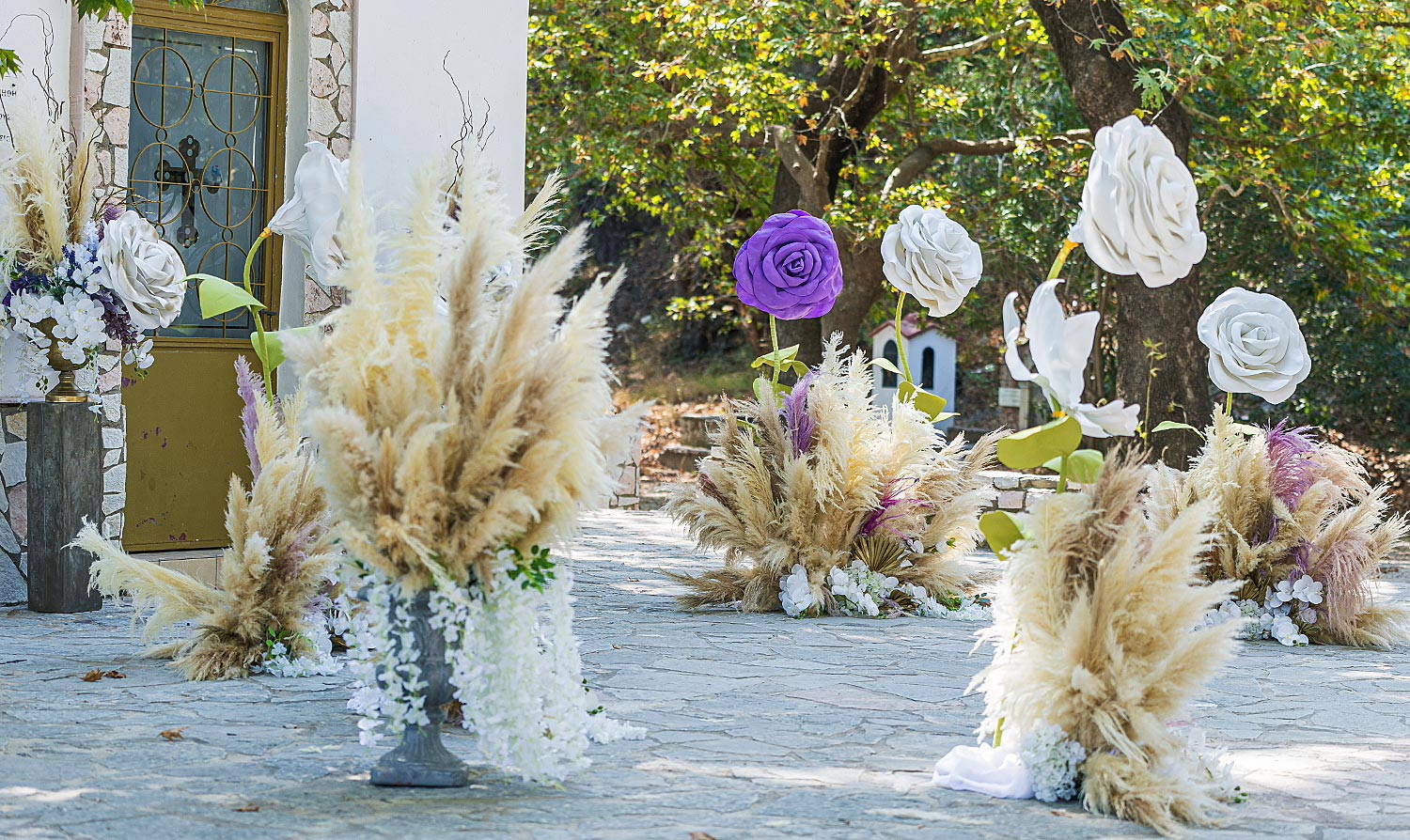 Whimsical Forest Christening with Oversized Floral Decor 10 Detail of giant handmade flowers and pampas grass for a forest baptism by Rogdaki Events
