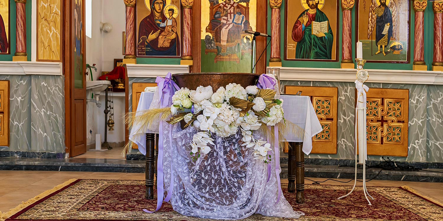 Whimsical Forest Christening with Oversized Floral Decor 9 Elegant baptismal font decoration with fresh flowers and lilac ribbons by Rogdaki Events