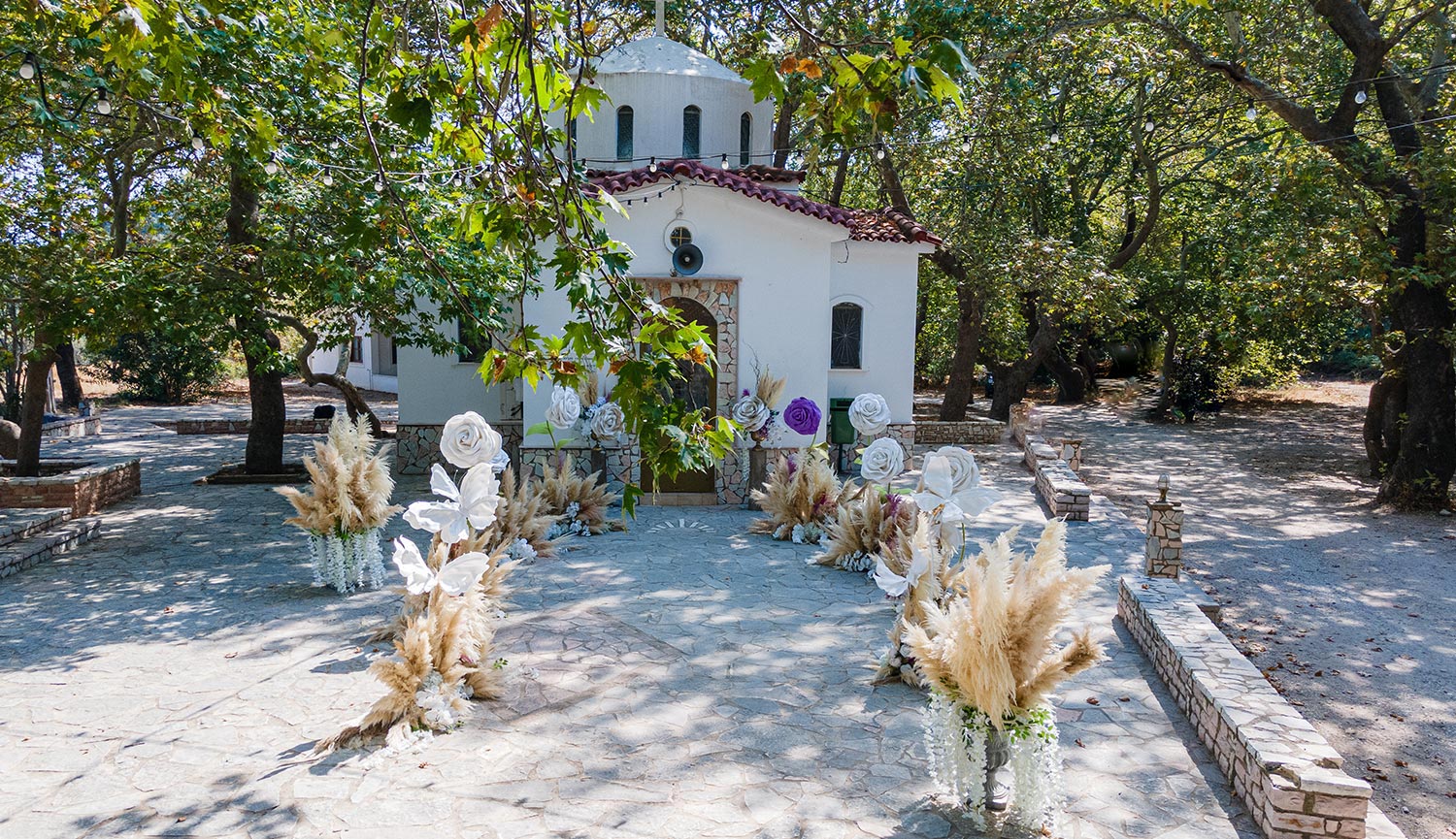 Whimsical Forest Christening with Oversized Floral Decor 3 Fairytale church entrance with oversized floral decor and pampas grass by Rogdaki Events